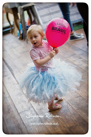Little girl holding balloon wearing Camden Brawl t-shirt